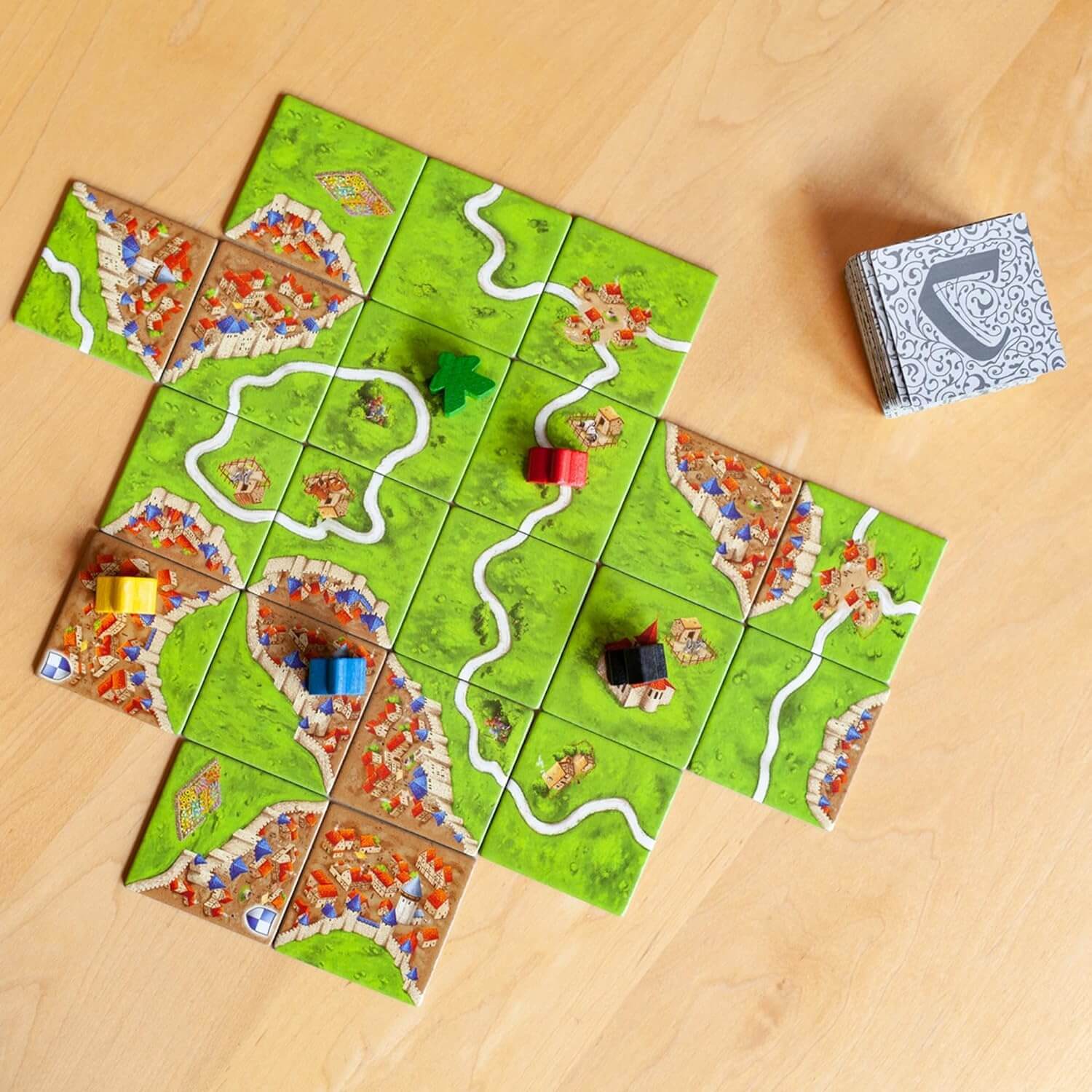 Carcassonne landscape tiles spread showing cities roads and farms – tile laying game India