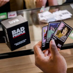 Bad People game in action at a group hangout with players holding voting cards — social party card game
