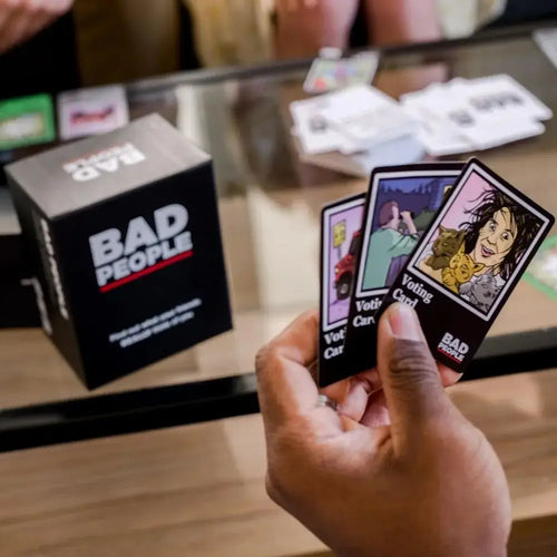 Bad People game in action at a group hangout with players holding voting cards — social party card game