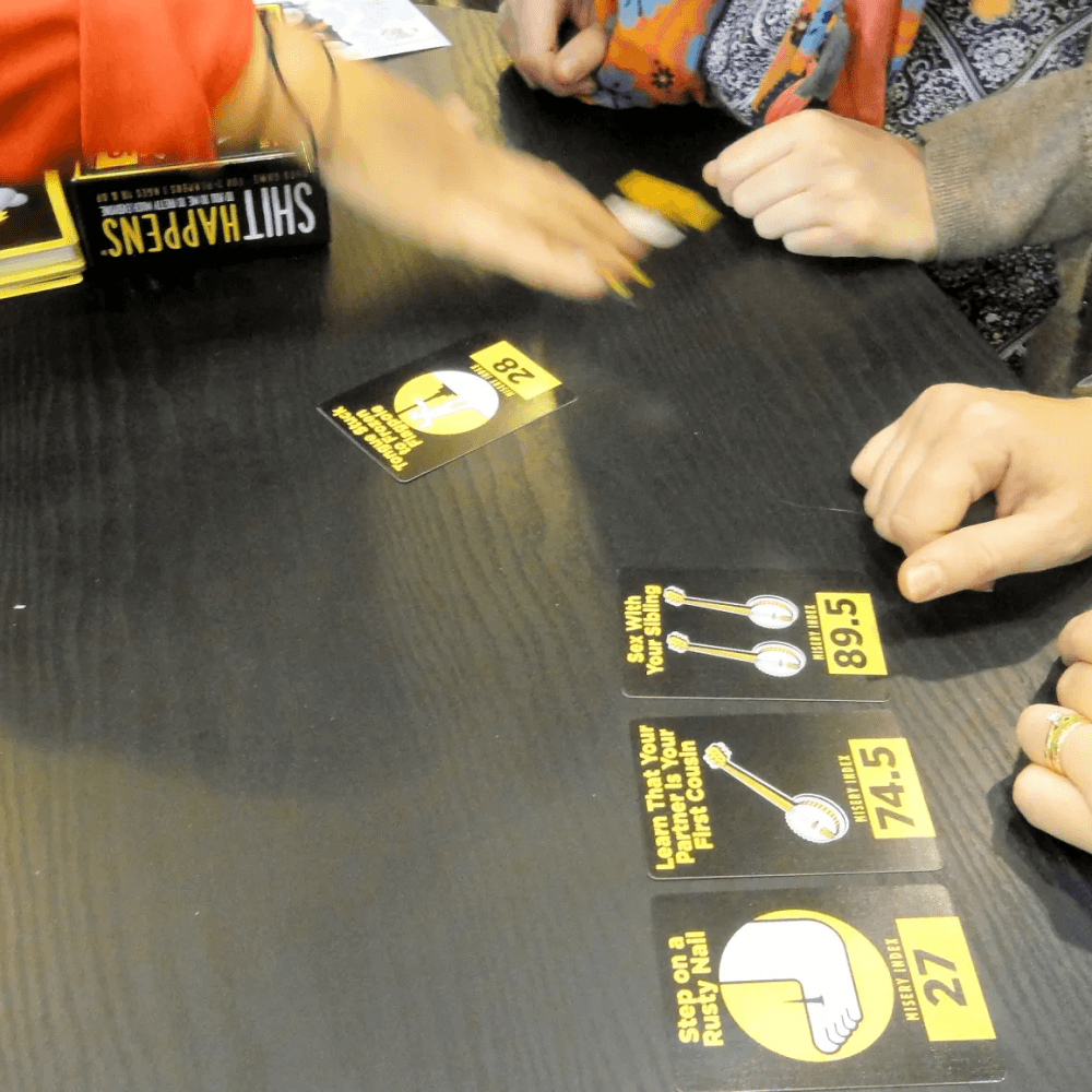 Shit Happens game being played with Lane of Pain lineup visible — dark humour adult card game for groups